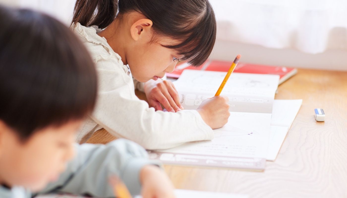 Children engaged in homework practice in a Kumon franchise business