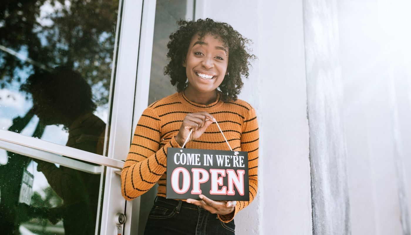 A young female franchise business owner holding a 