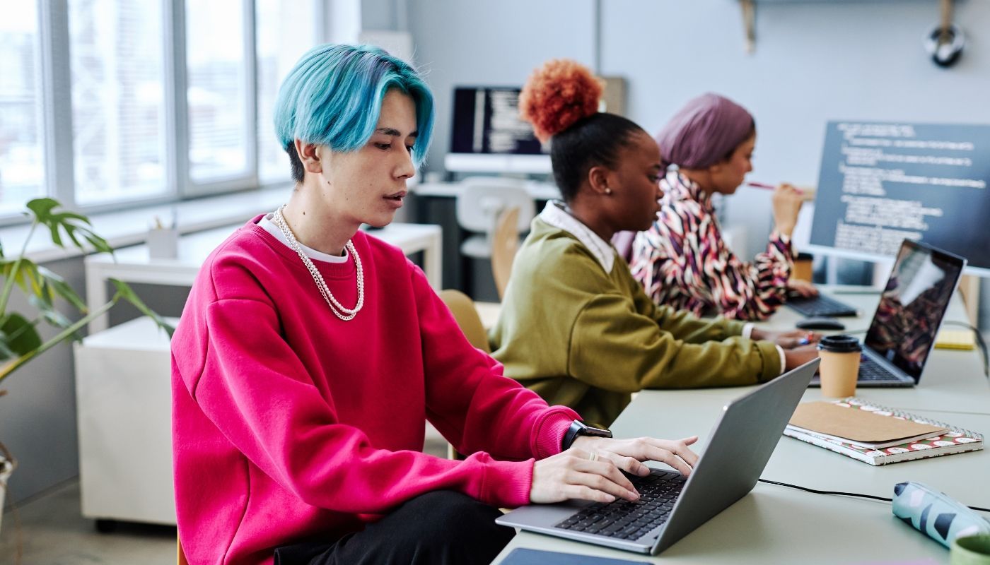 A Gen Z man working at a laptop and researching franchise opportunities