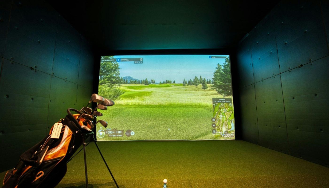 Adult man enjoying a game on a portable golf simulator.