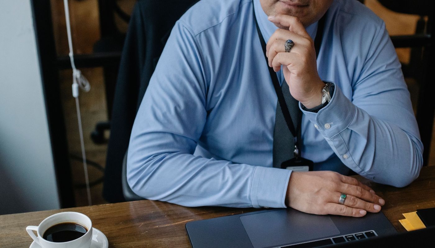 Businessman deep in thought while evaluating how to fund a franchise before investing.