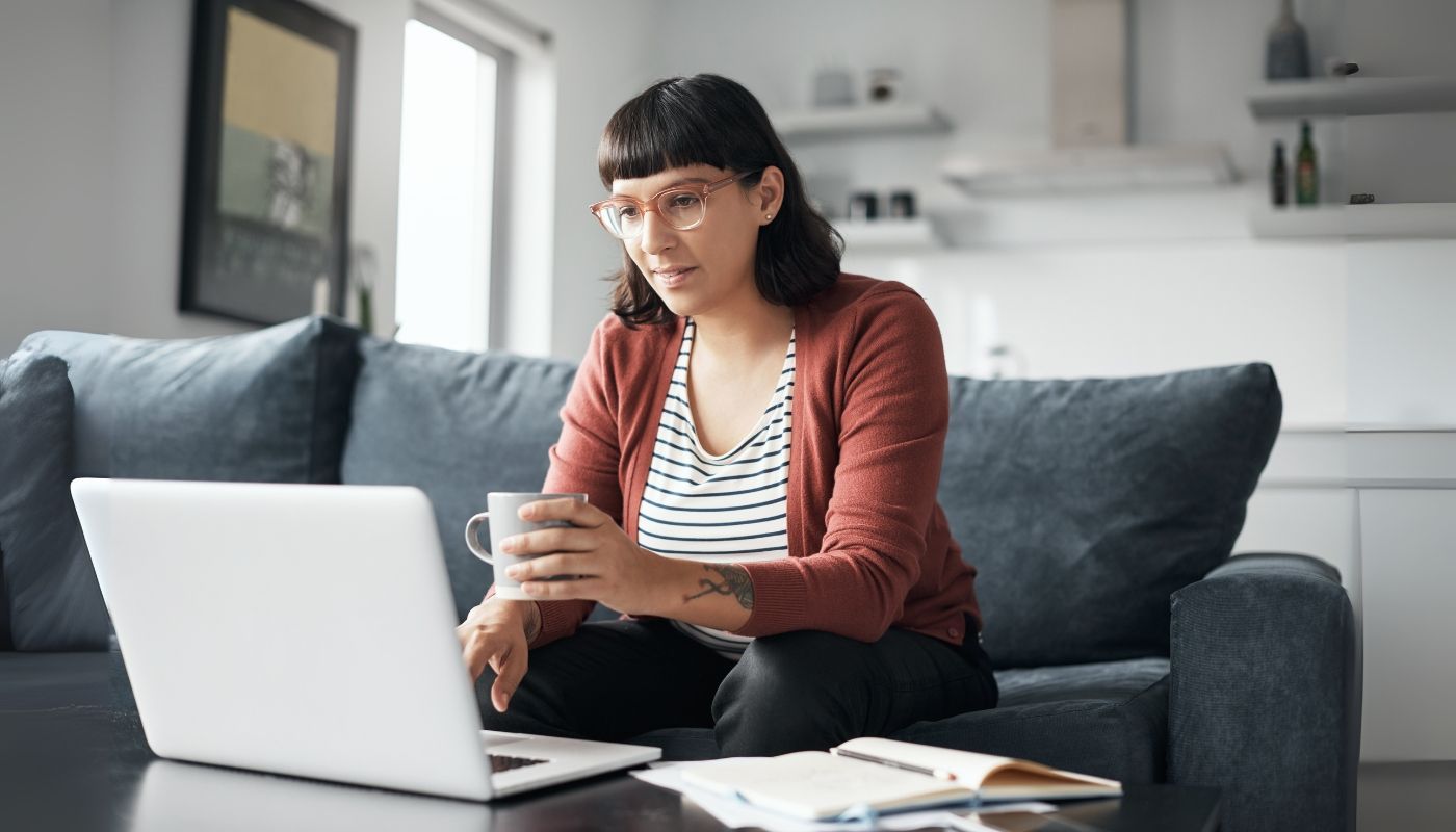 Woman using laptop to research about how to start a franchise
