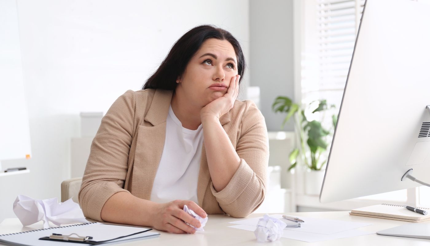 A bored young employee thinking about opening a franchise business