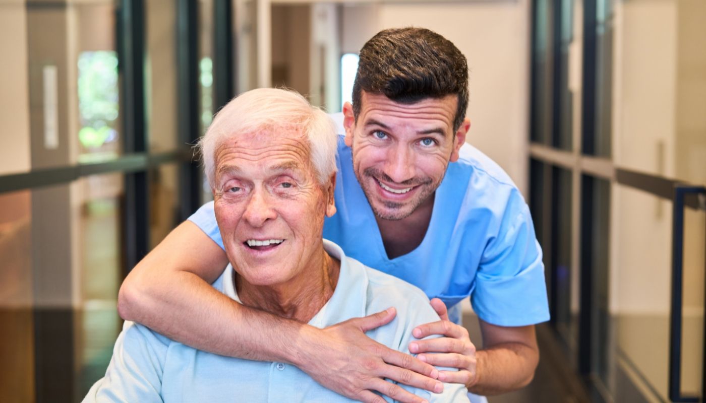 Friendly male caregiver working in a senior care franchise.