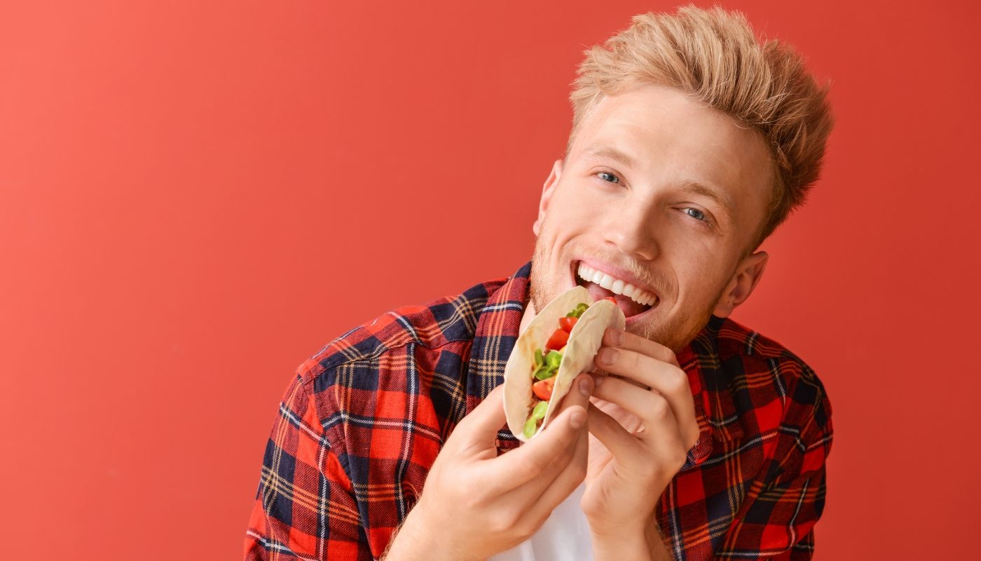 Man eating tacos from one of the most successful franchises to open today.