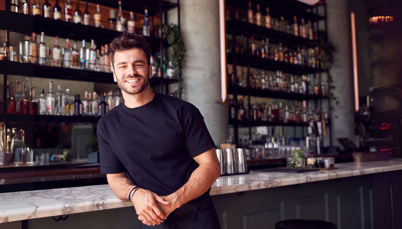 Young adult in front of a bar in a restaurant type of franchise