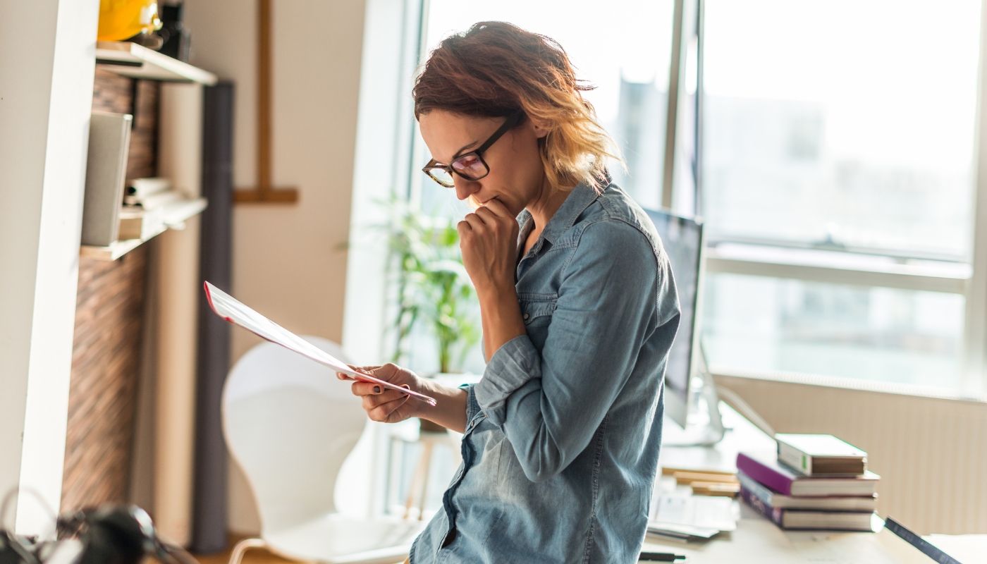 A woman reading a contract and wondering what is a franchise disclosure document.