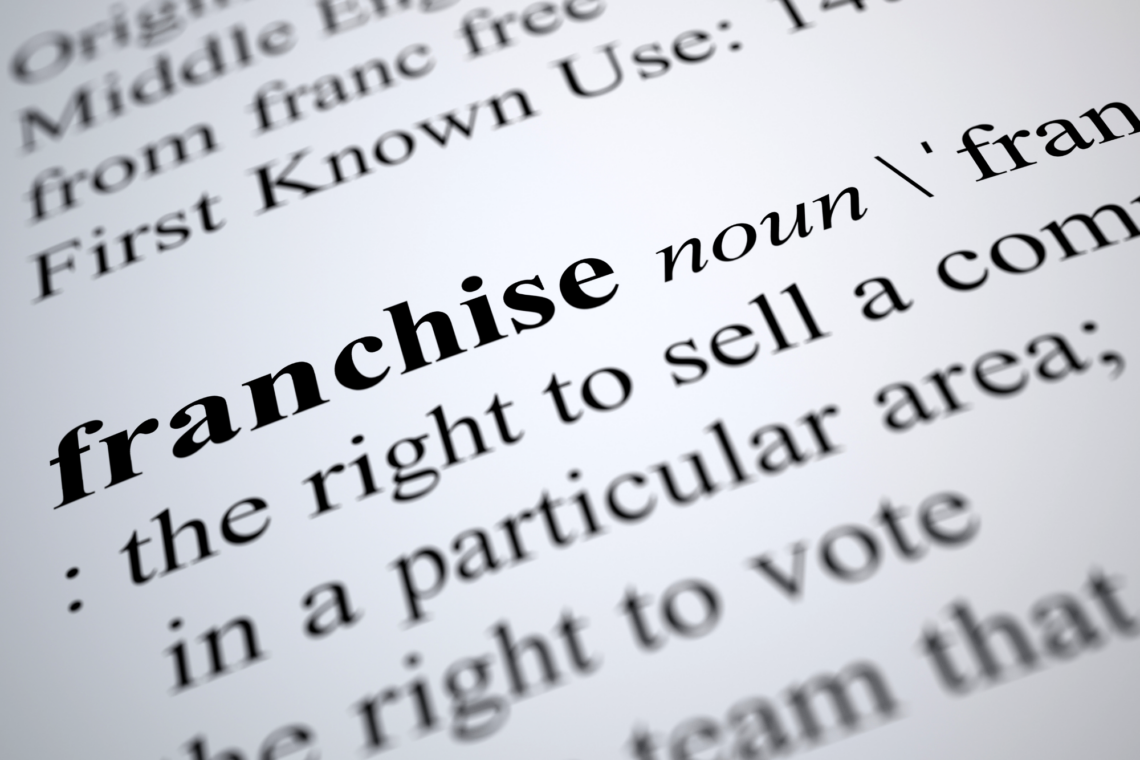 The word franchise is on a piece of paper