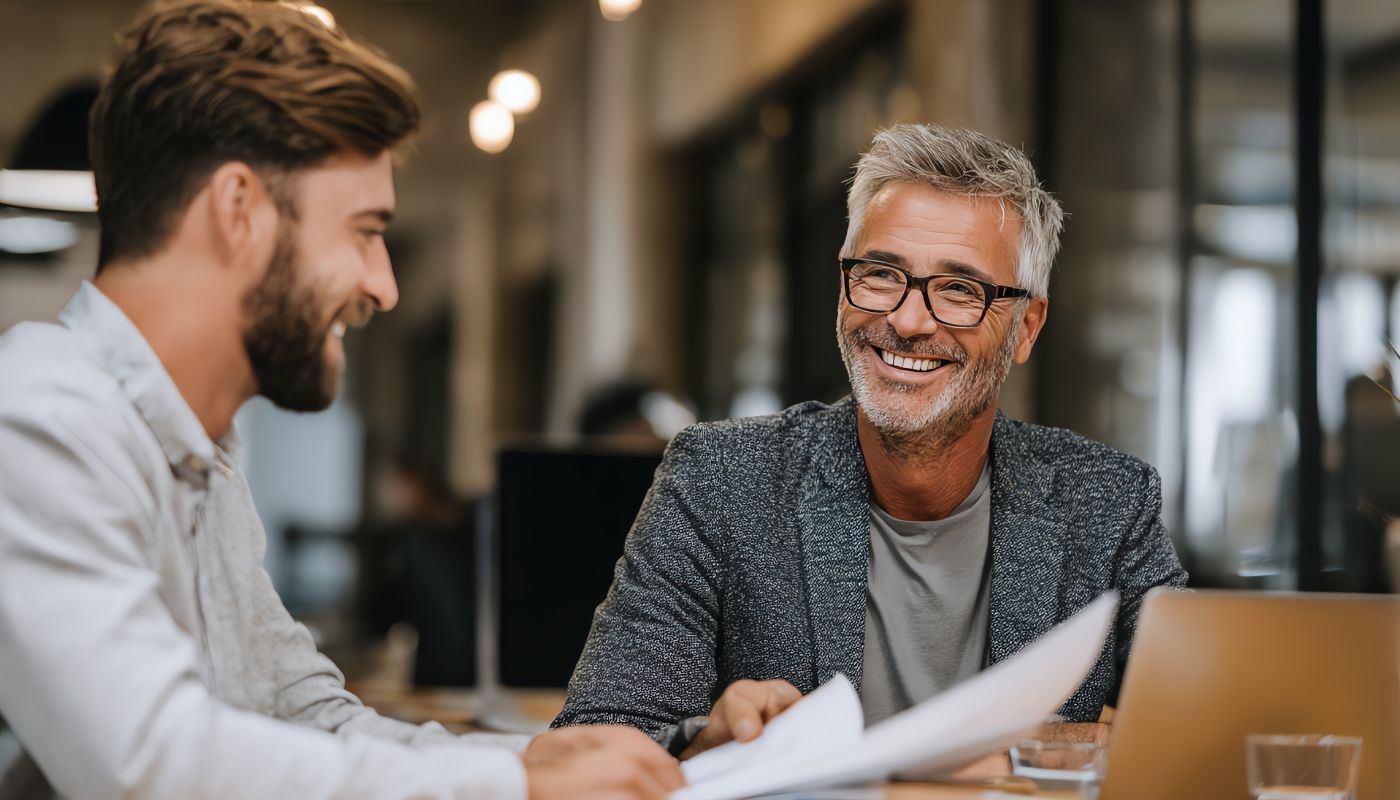 Consultant giving business advice to a young client, showing why you should hire a franchise consultant when evaluating franchise opportunities.