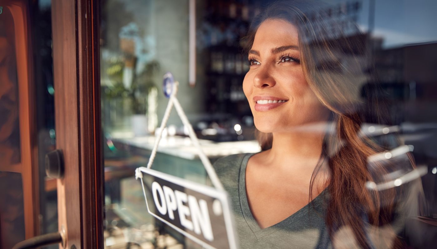 A woman in a franchise thinking about why you should invest in a franchise.