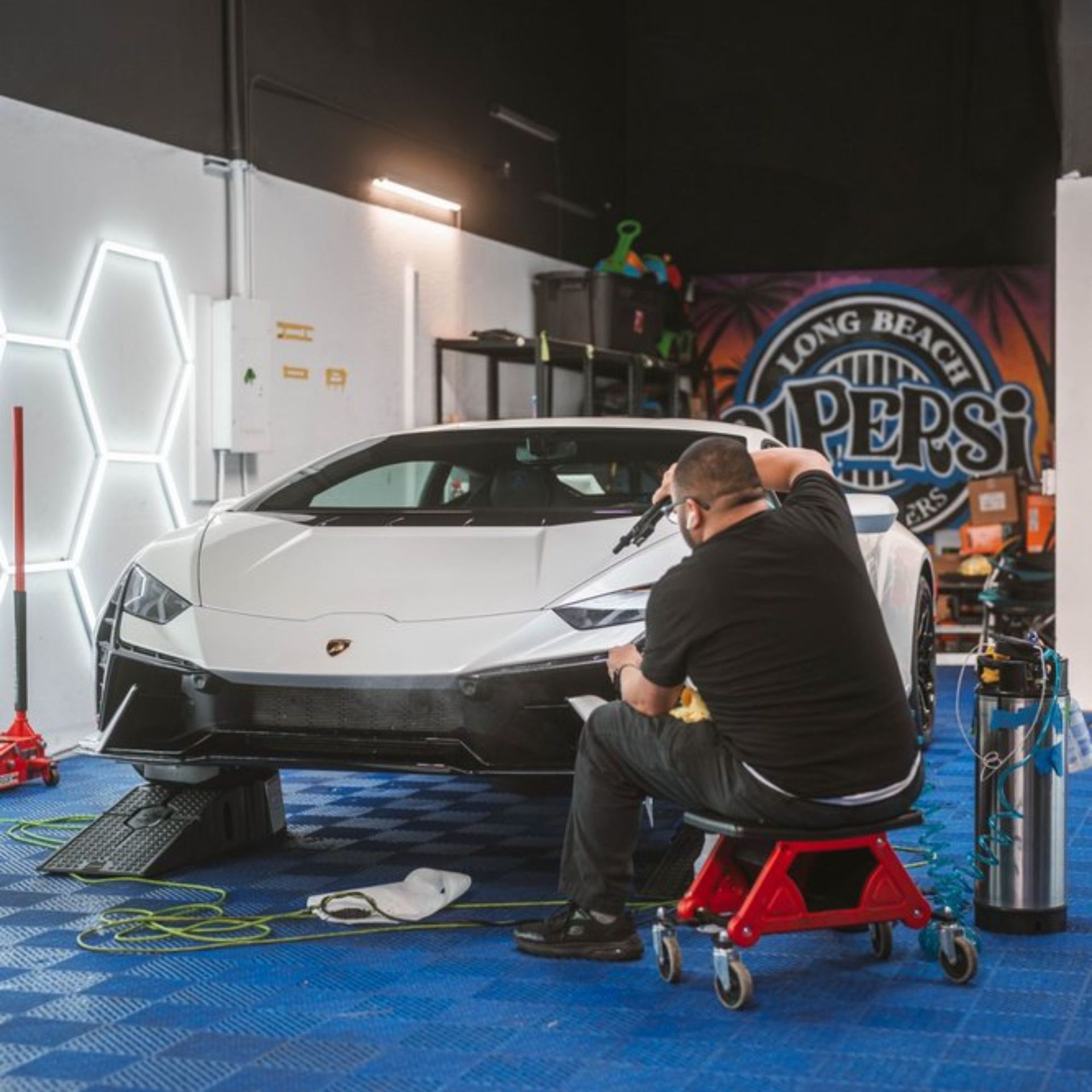 Dark gray Tesla sedan, side view, tinted windows.