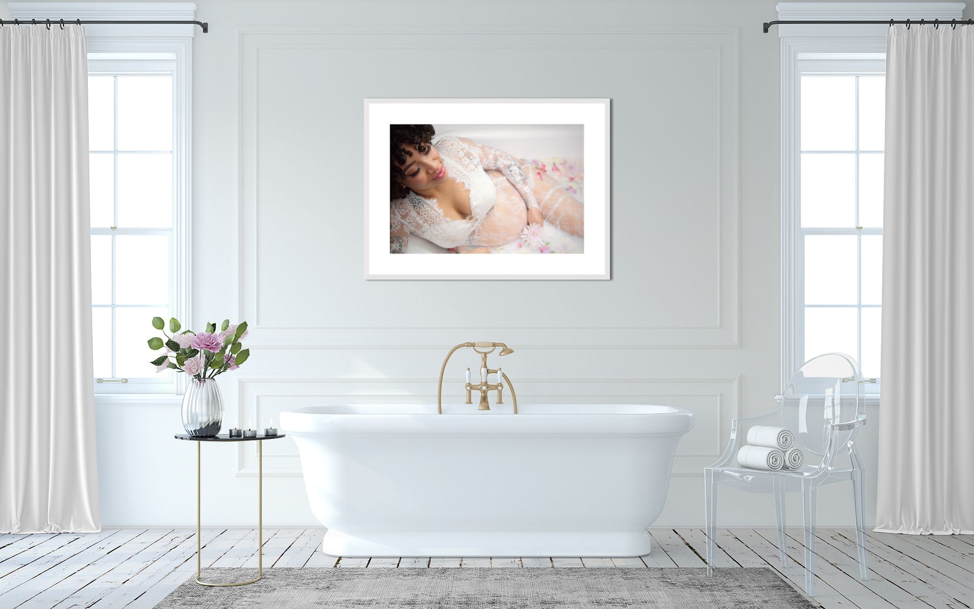 A woman in a bedroom-style bathroom, framed photo above a bathtub.