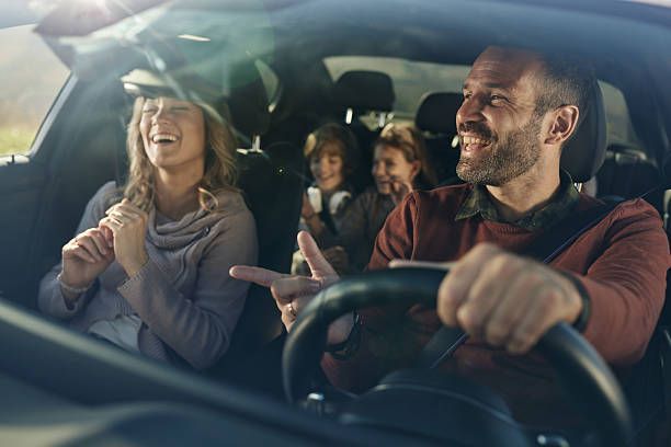 Happy family driving safely with a clear, undamaged car windshield.