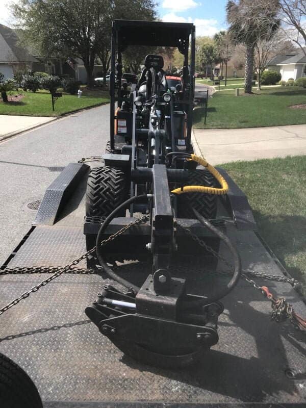 Excavator on Truck — Middleburg, FL — Absolute Tree and Stump Inc