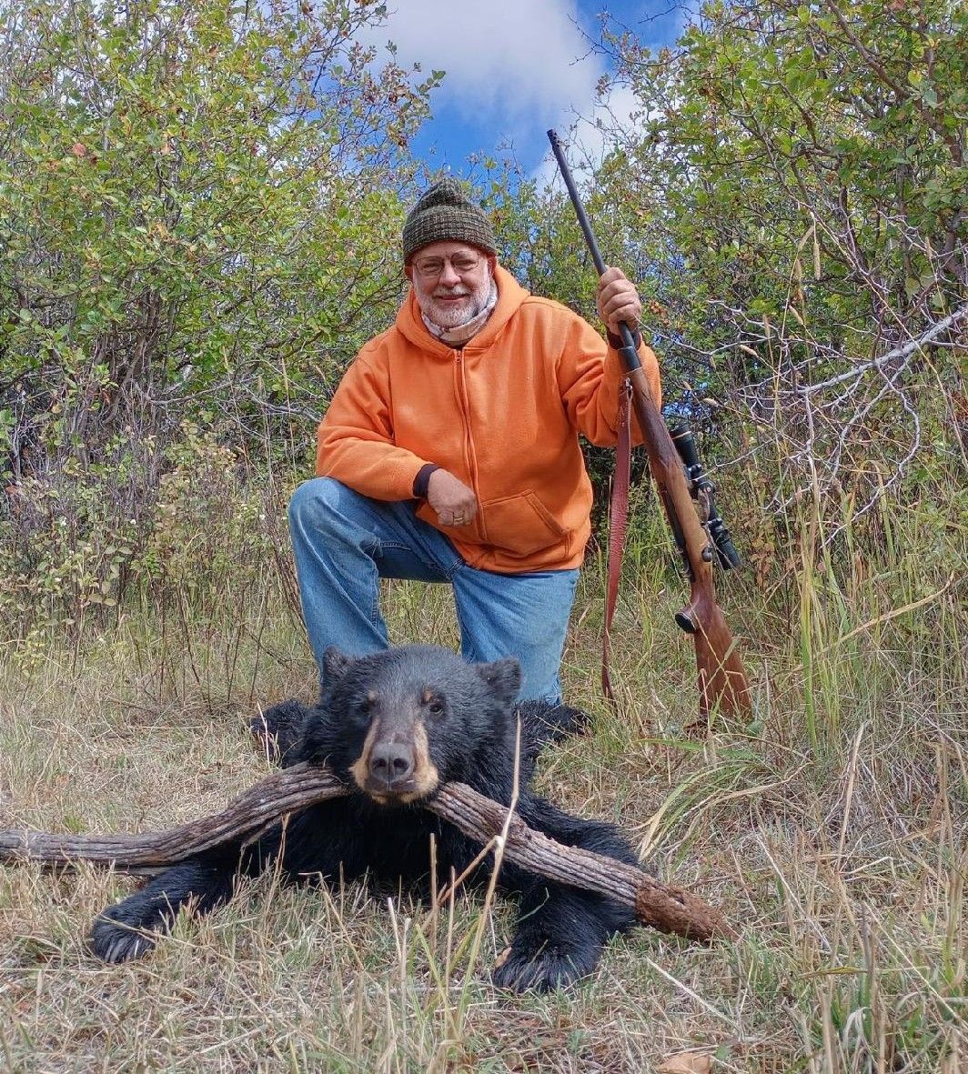 A man with a black bear.