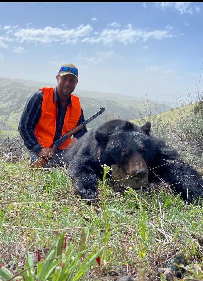 A man with a black bear.