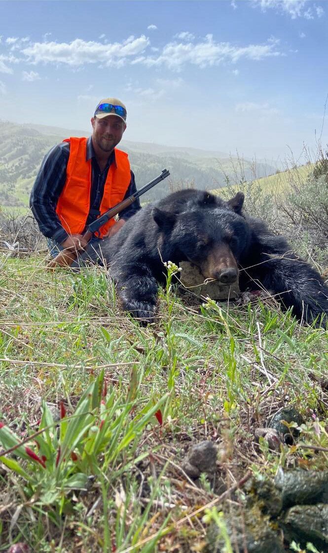 A man with a black bear.