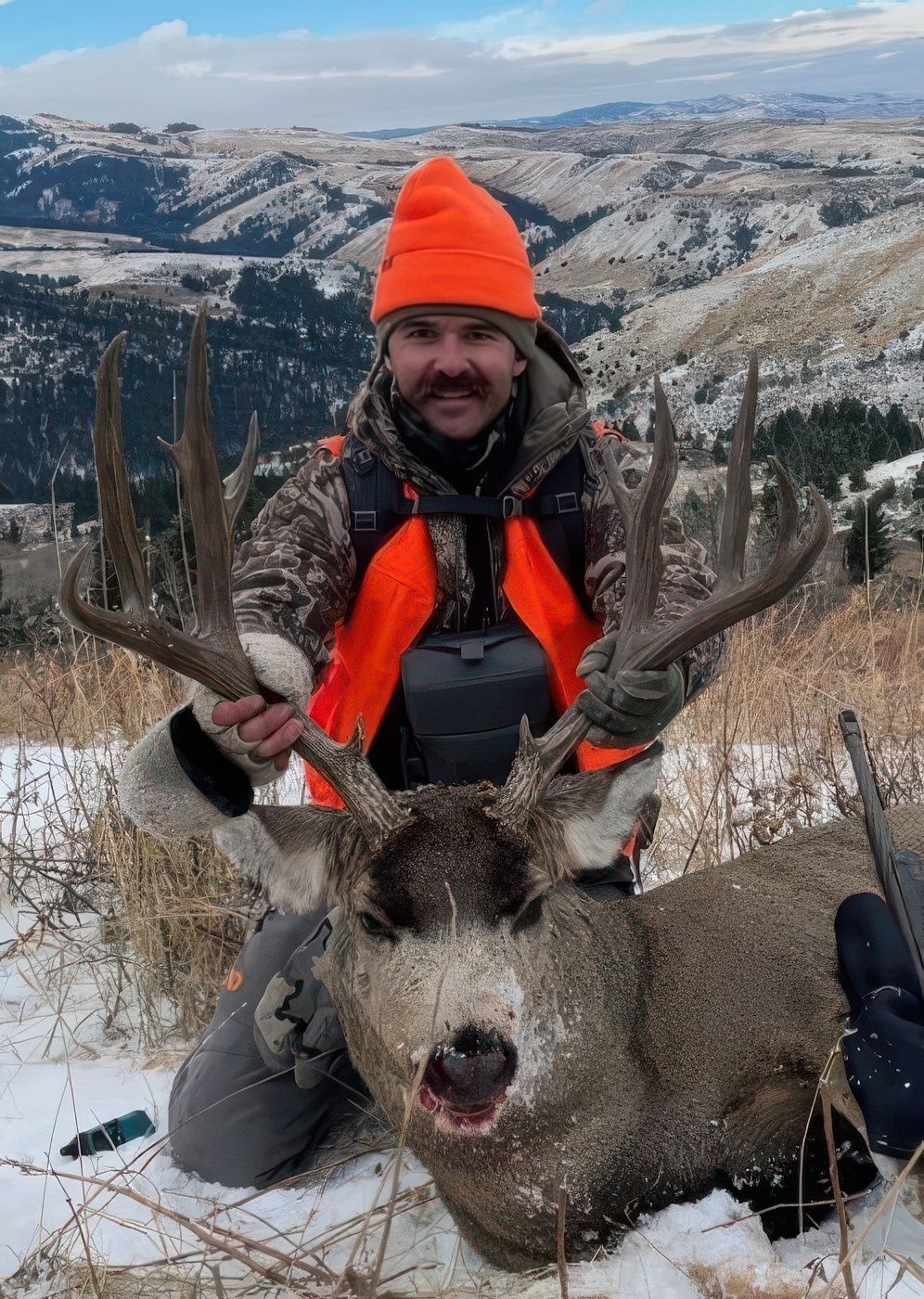 A man holding a big deer.