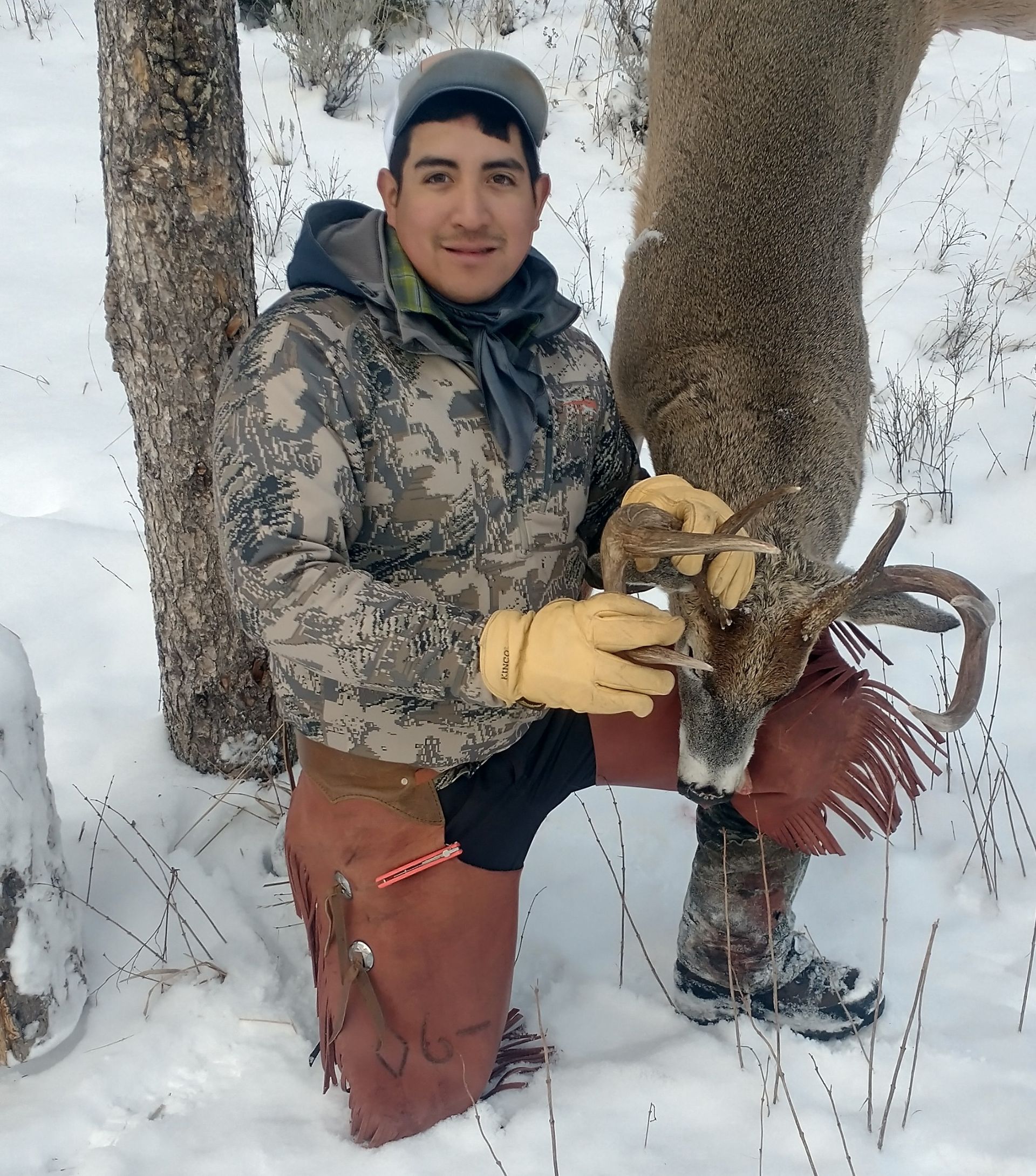 A man holding a big deer.