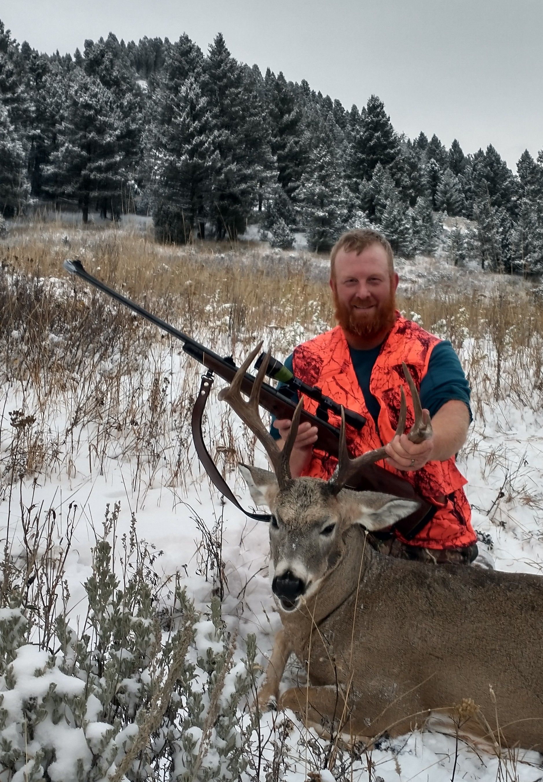 A man holding a big deer.