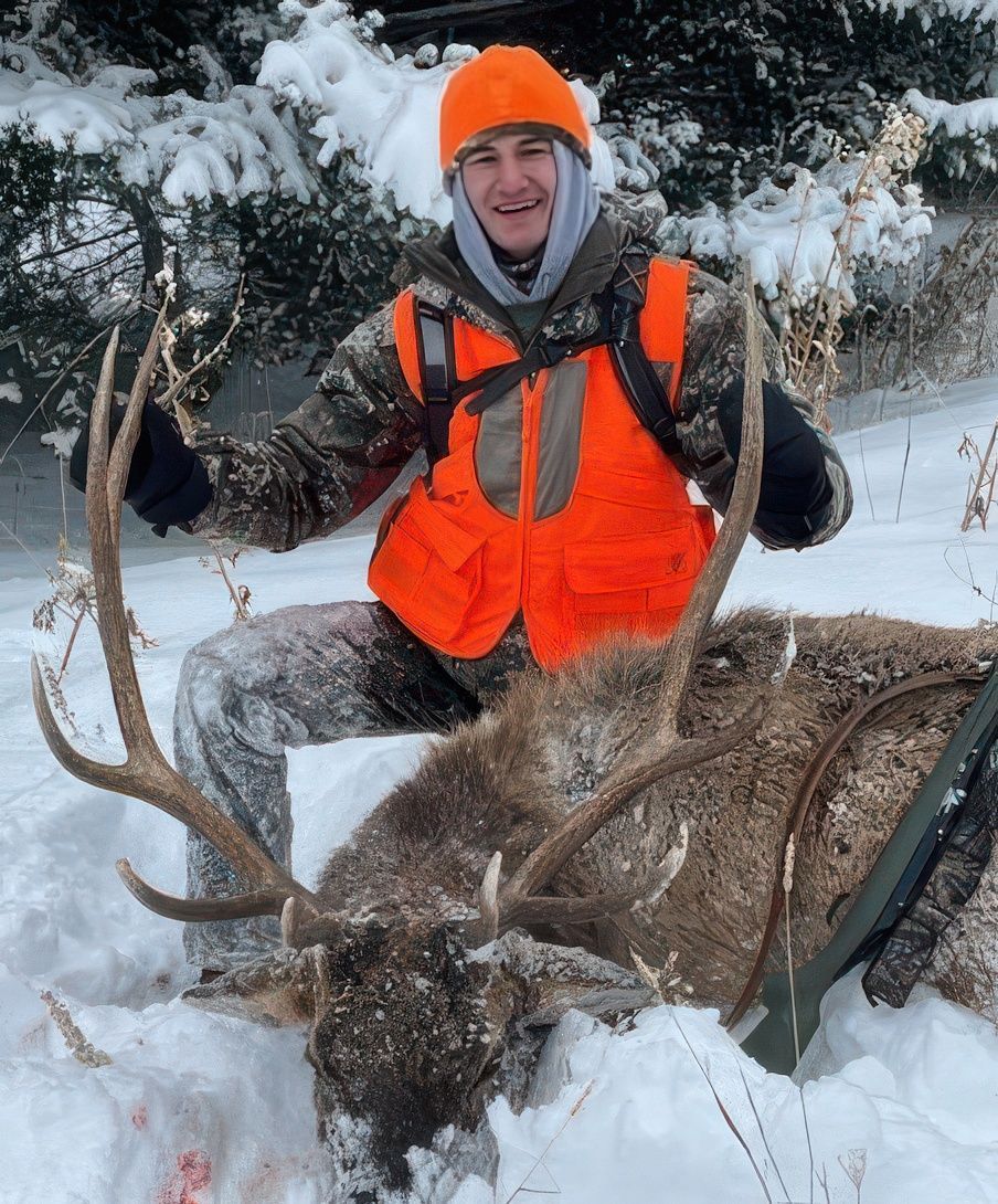 A man holding a big elk.