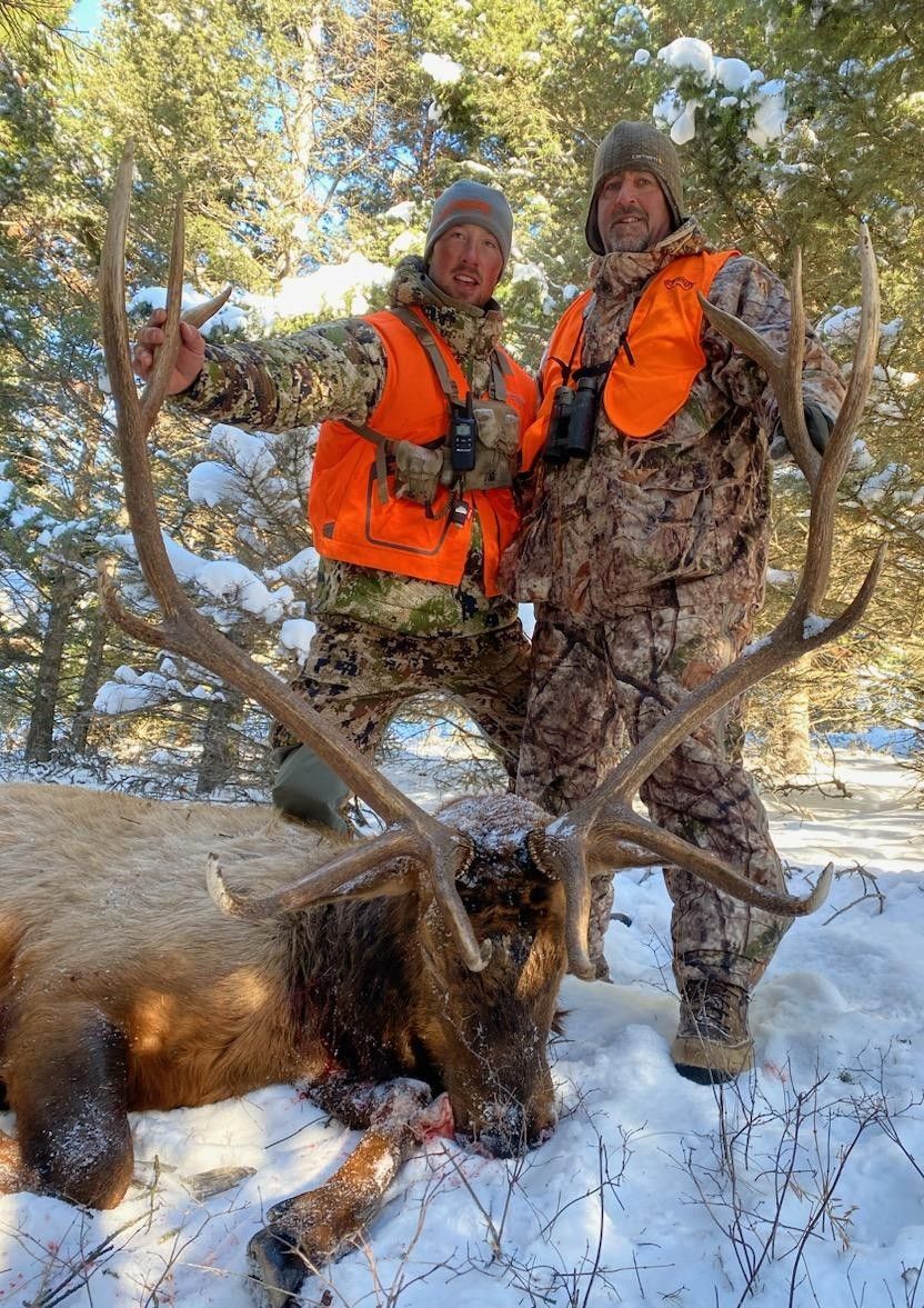 Men holding a big elk.