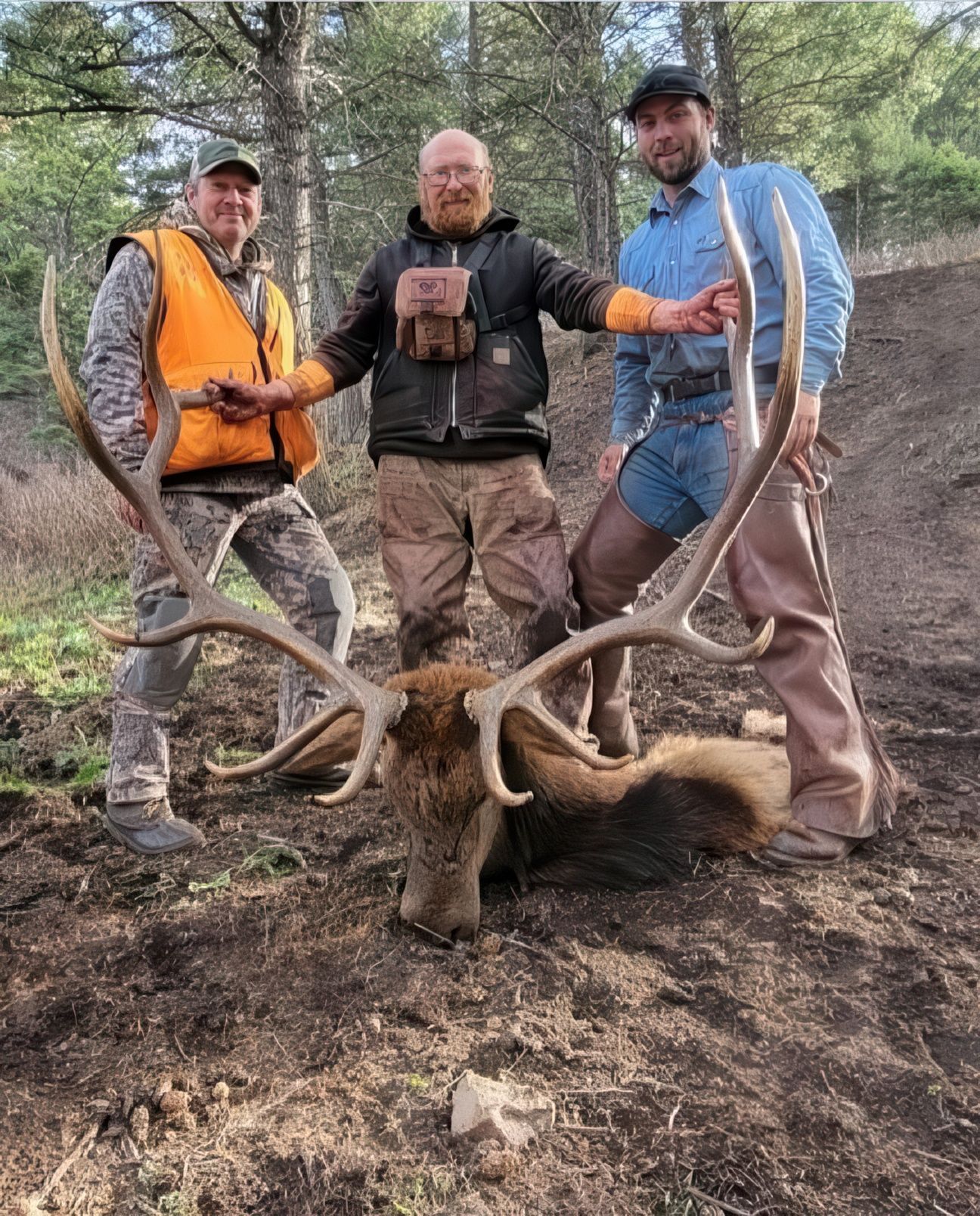 Men holding a big elk.