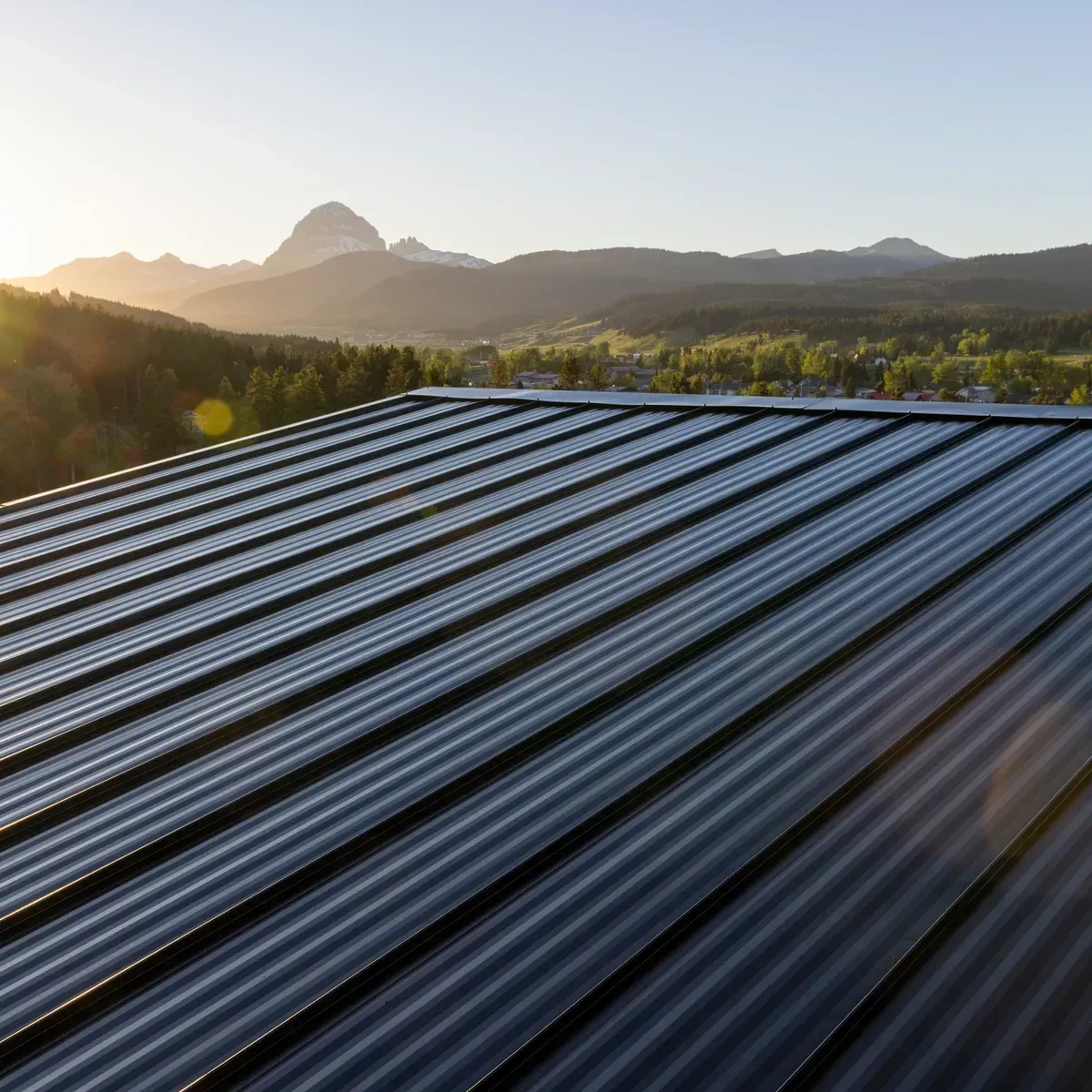 Solar panel roof with mountains and sunrise in the background