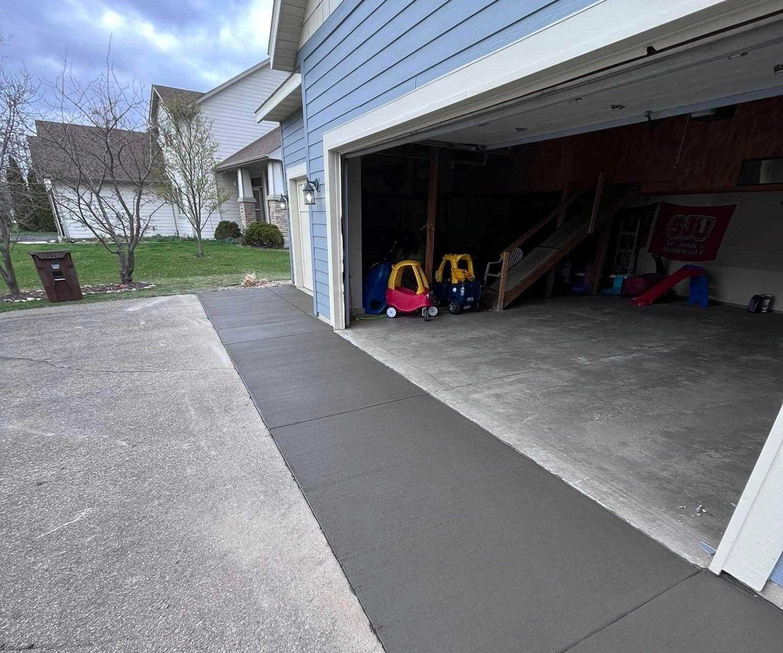 A Garage With A Concrete Driveway — Cambridge, MN — Superior Companies MN A Garage With A Concrete Driveway — Cambridge, MN — Superior Companies MN