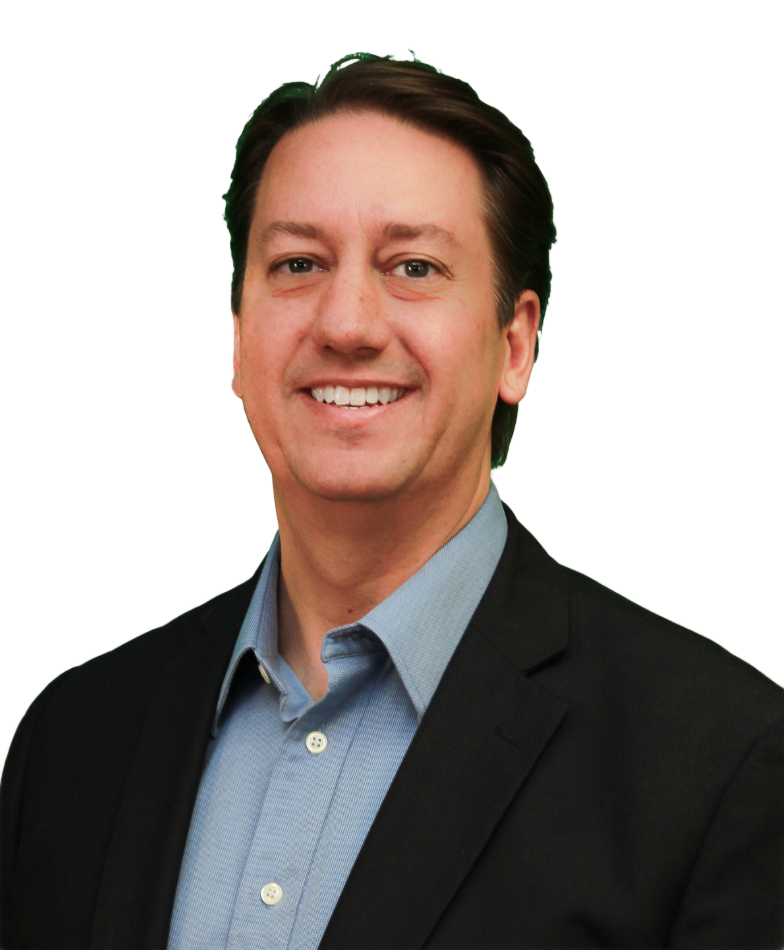 Smiling man in black suit and blue shirt, against a white background.