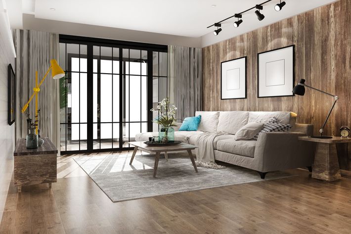 A living room with a couch , coffee table , and sliding glass doors.