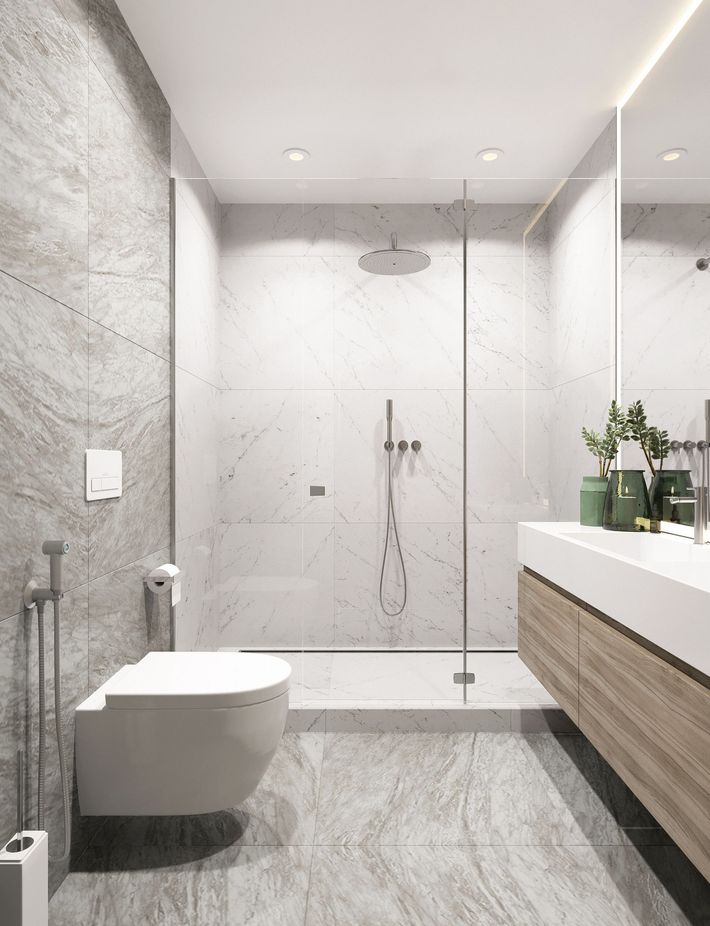 A bathroom with a toilet , sink and shower.