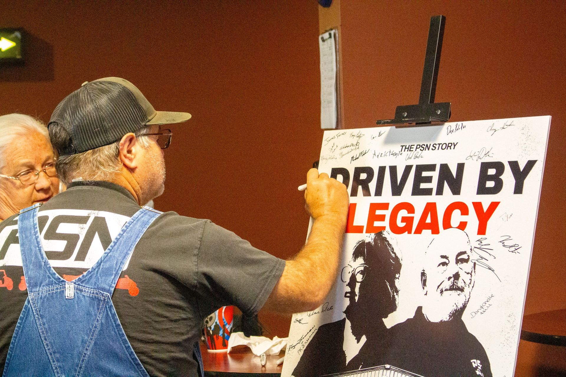 Two children in front of a brown truck with a boxy office on the back; advertising real estate services.