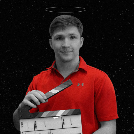 Man in red shirt holding a film clapperboard against a black starry background, with a halo above his head.