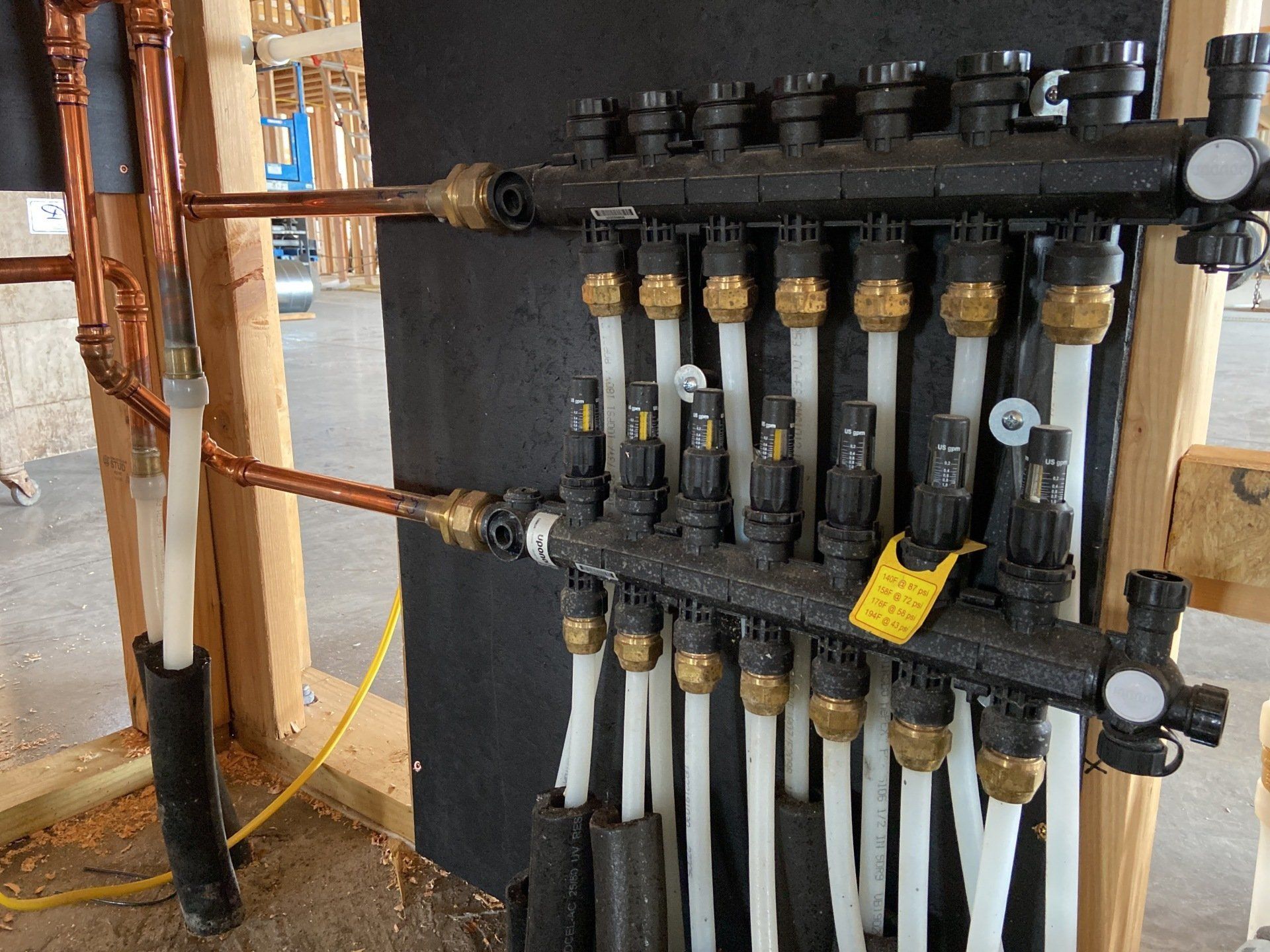 A bunch of pipes are connected to a wall.