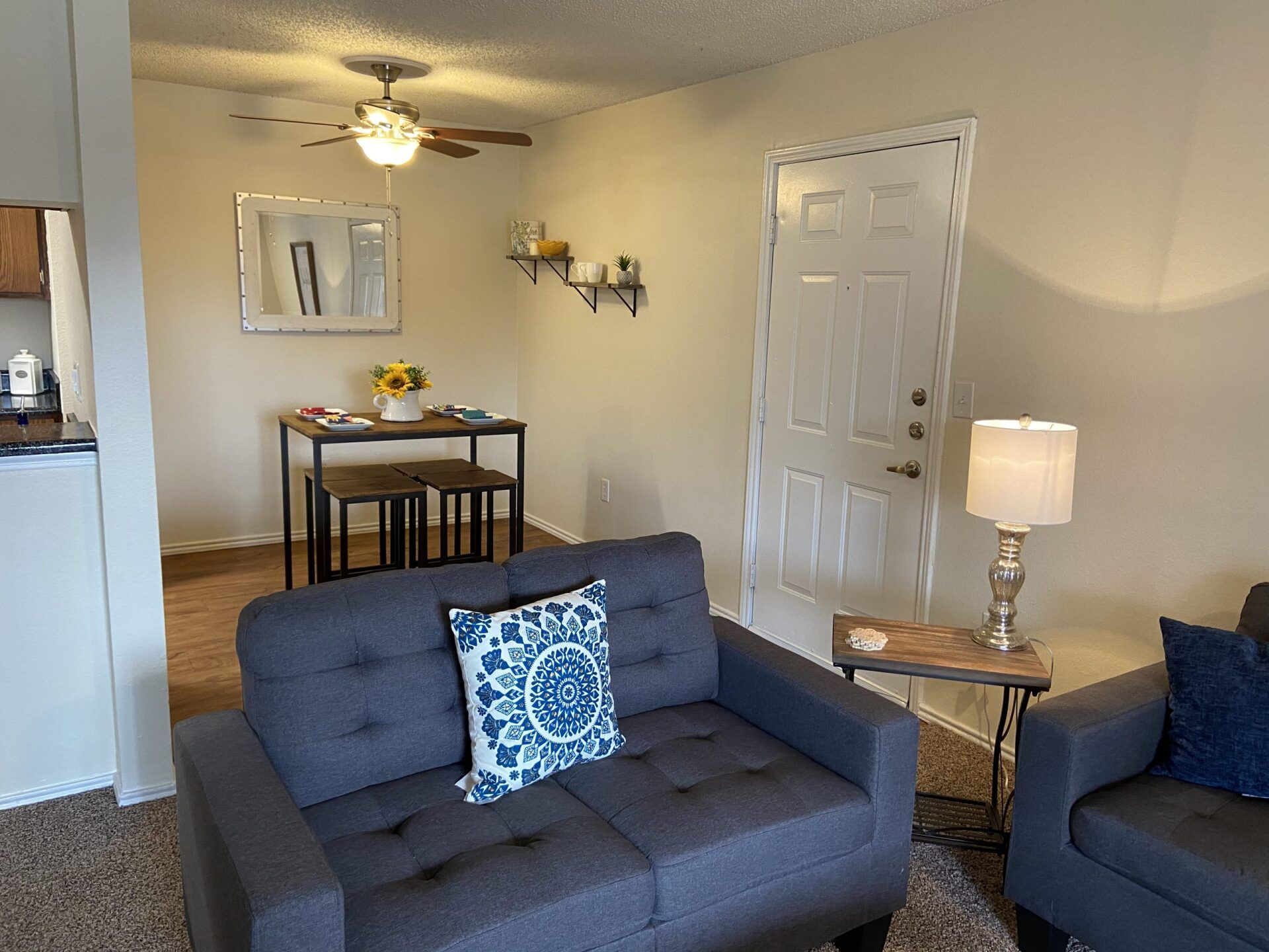 Interior of living room with dining nook, and entryway to outside in view