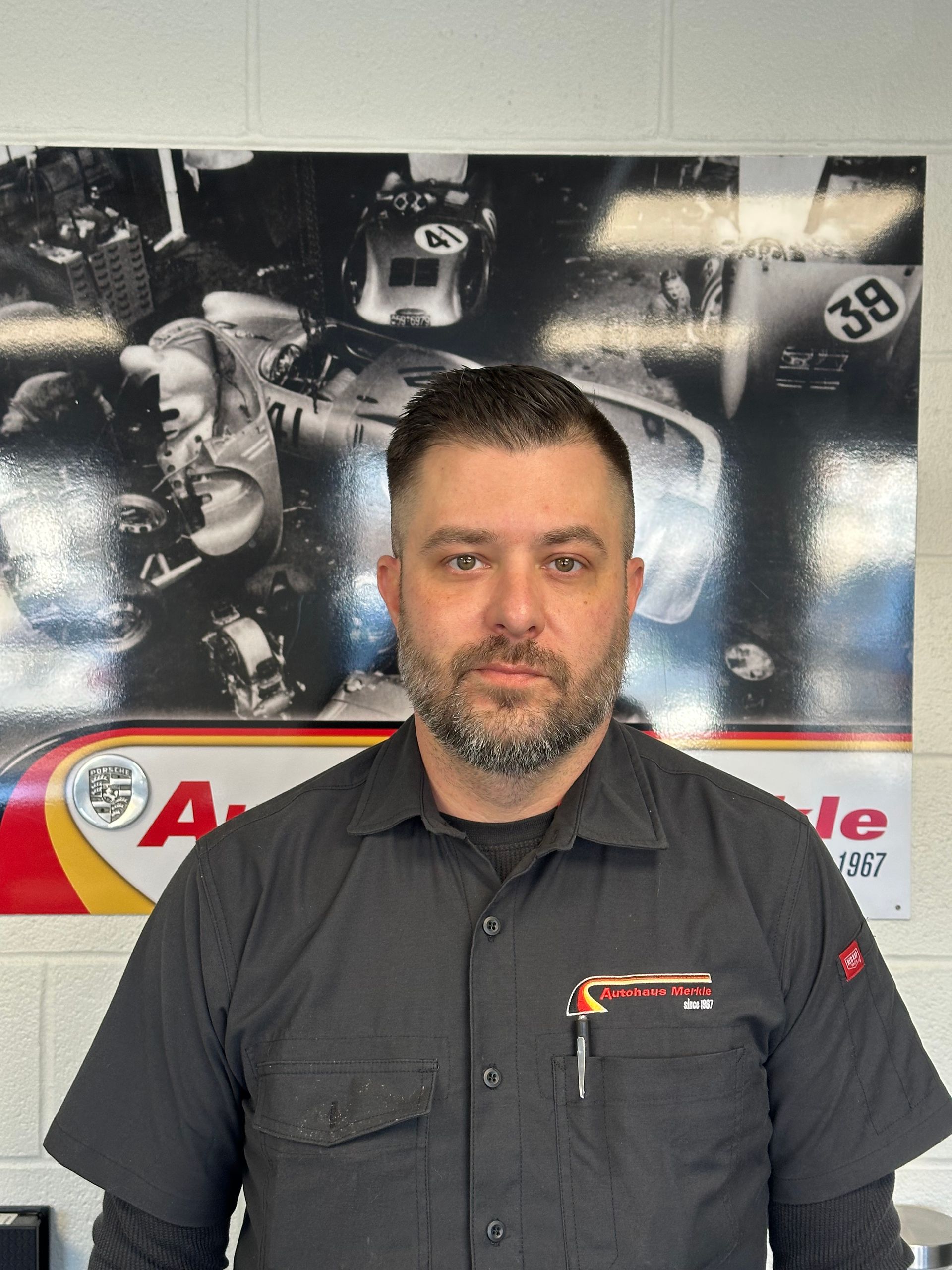 A man is standing behind a counter in a store.