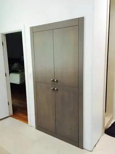 A room with a closet and a door leading to a bedroom.
