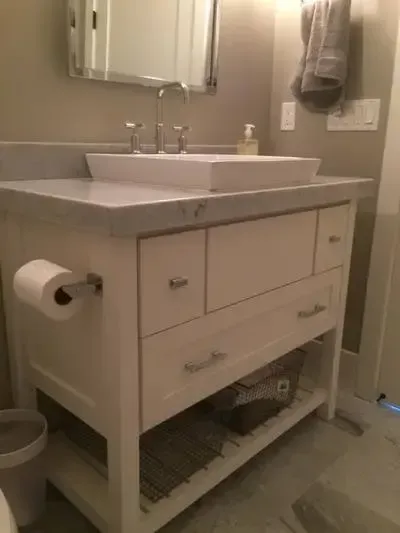 A bathroom vanity with a sink and a mirror.