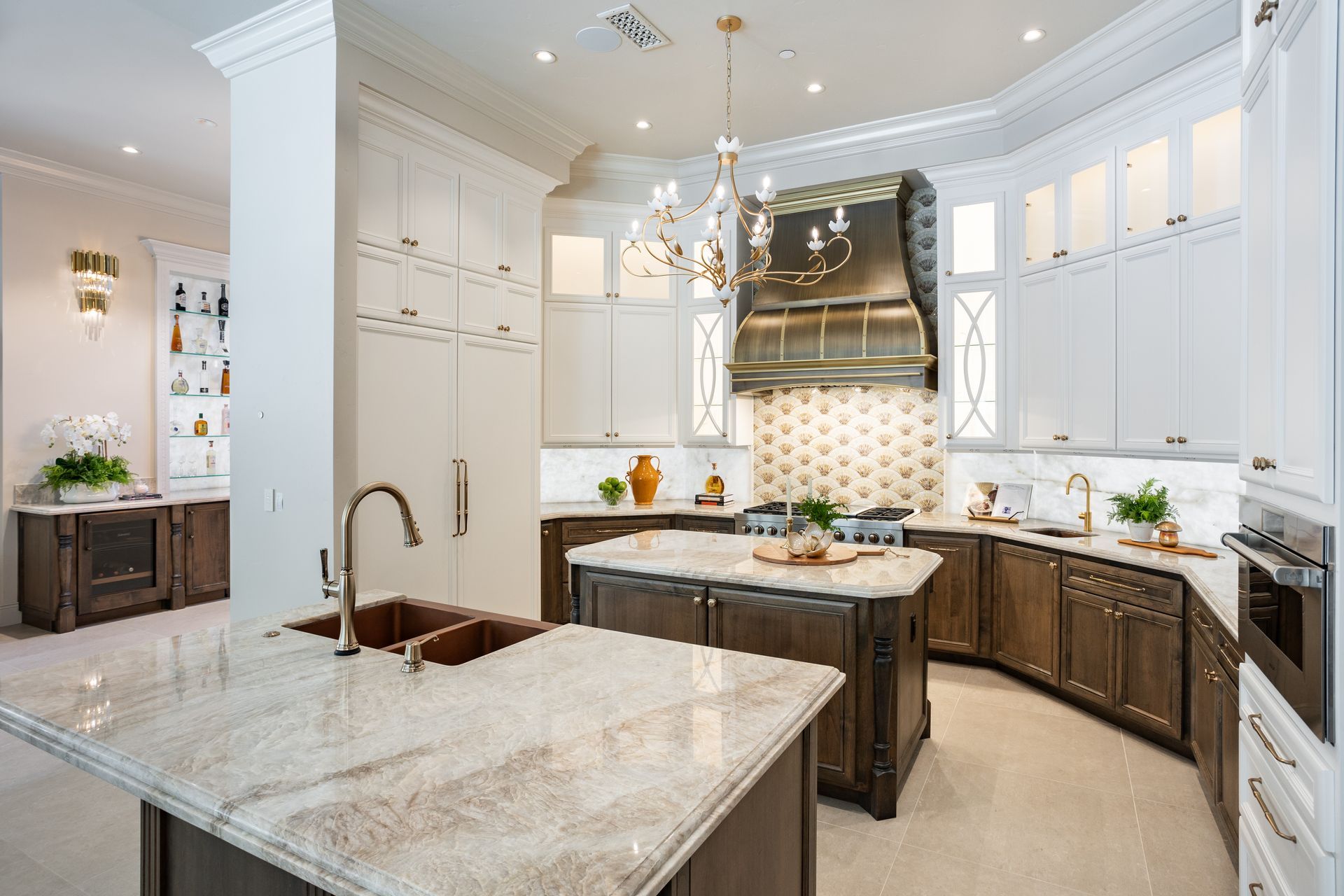 A kitchen with white cabinets , a blender , a dishwasher and a window.