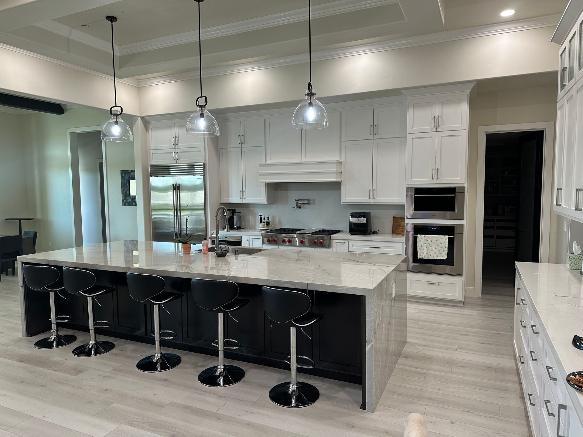 A large kitchen with a large island and stools.