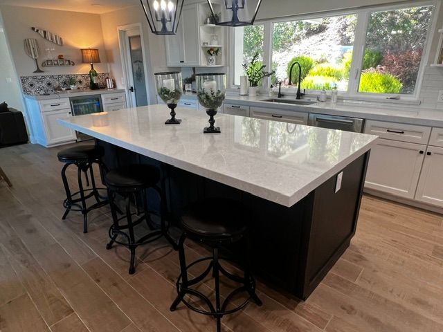 A kitchen with a large island and stools