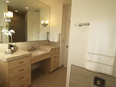 A bathroom with a sink and a large mirror