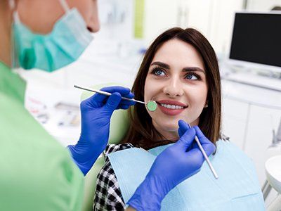 Dentist Examines Patient’s Teeth — Boca Raton, FL — Keith H. Kaner, DDS, PA