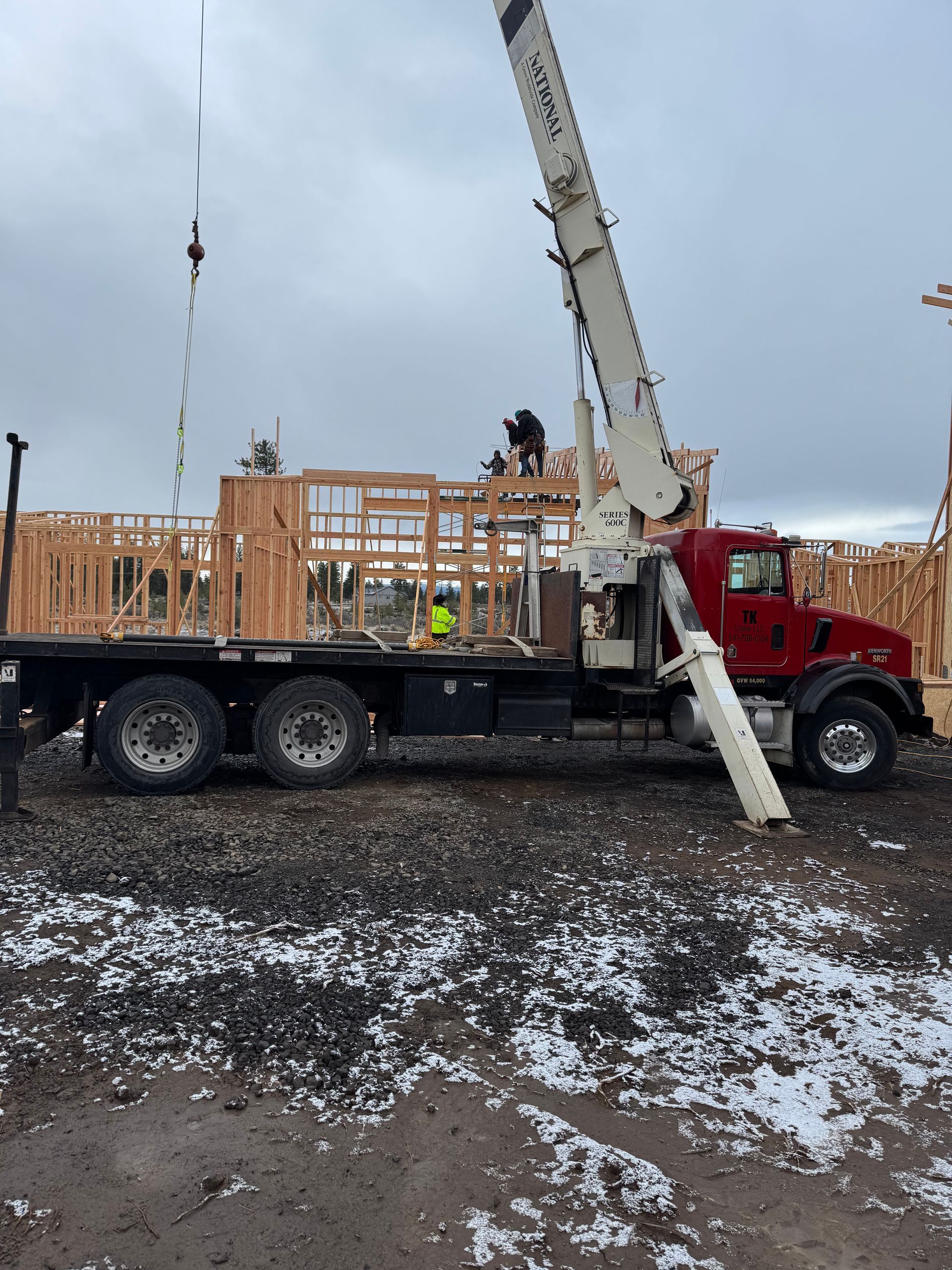 A red truck with a crane on top of it