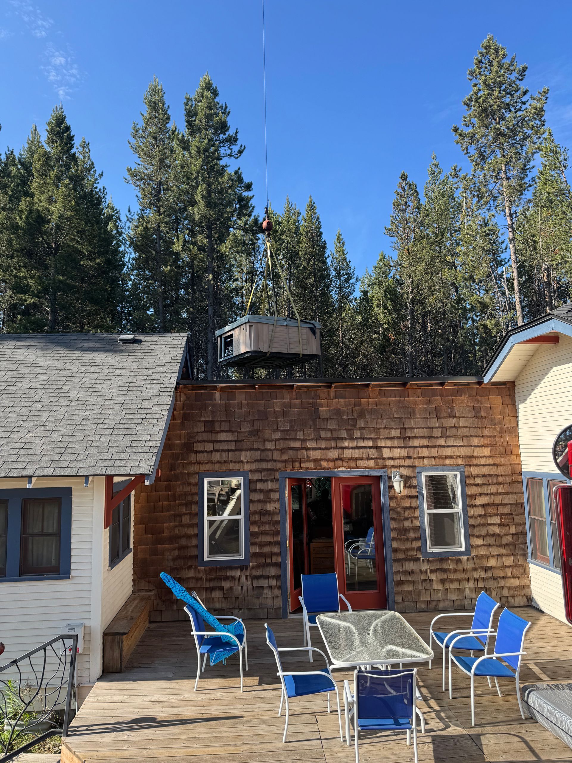 A house with a table and chairs in front of it