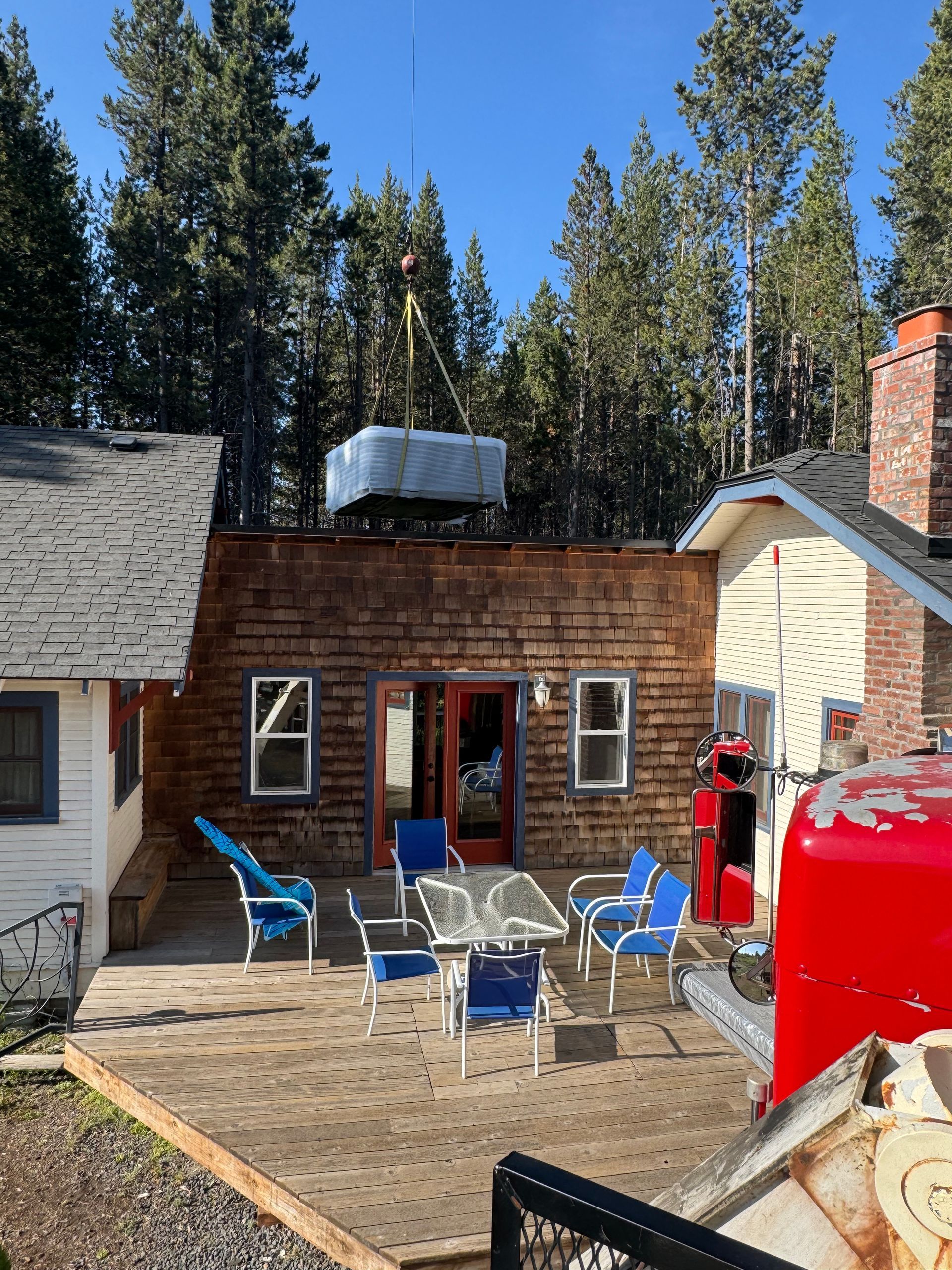 A red truck is parked in front of a house