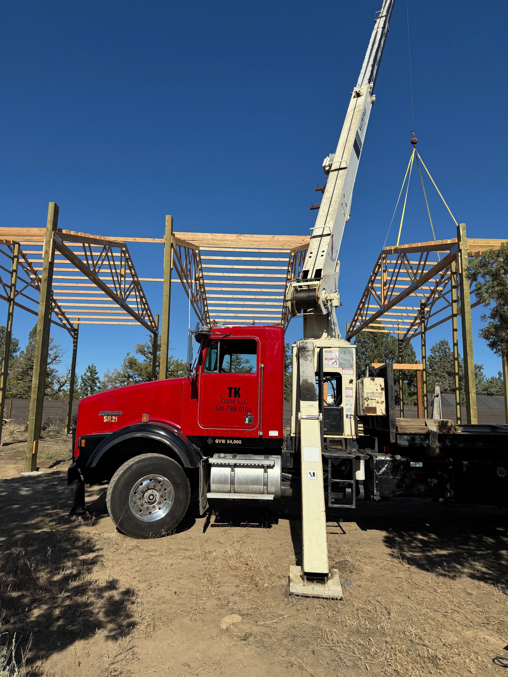 A red truck with a crane attached to it