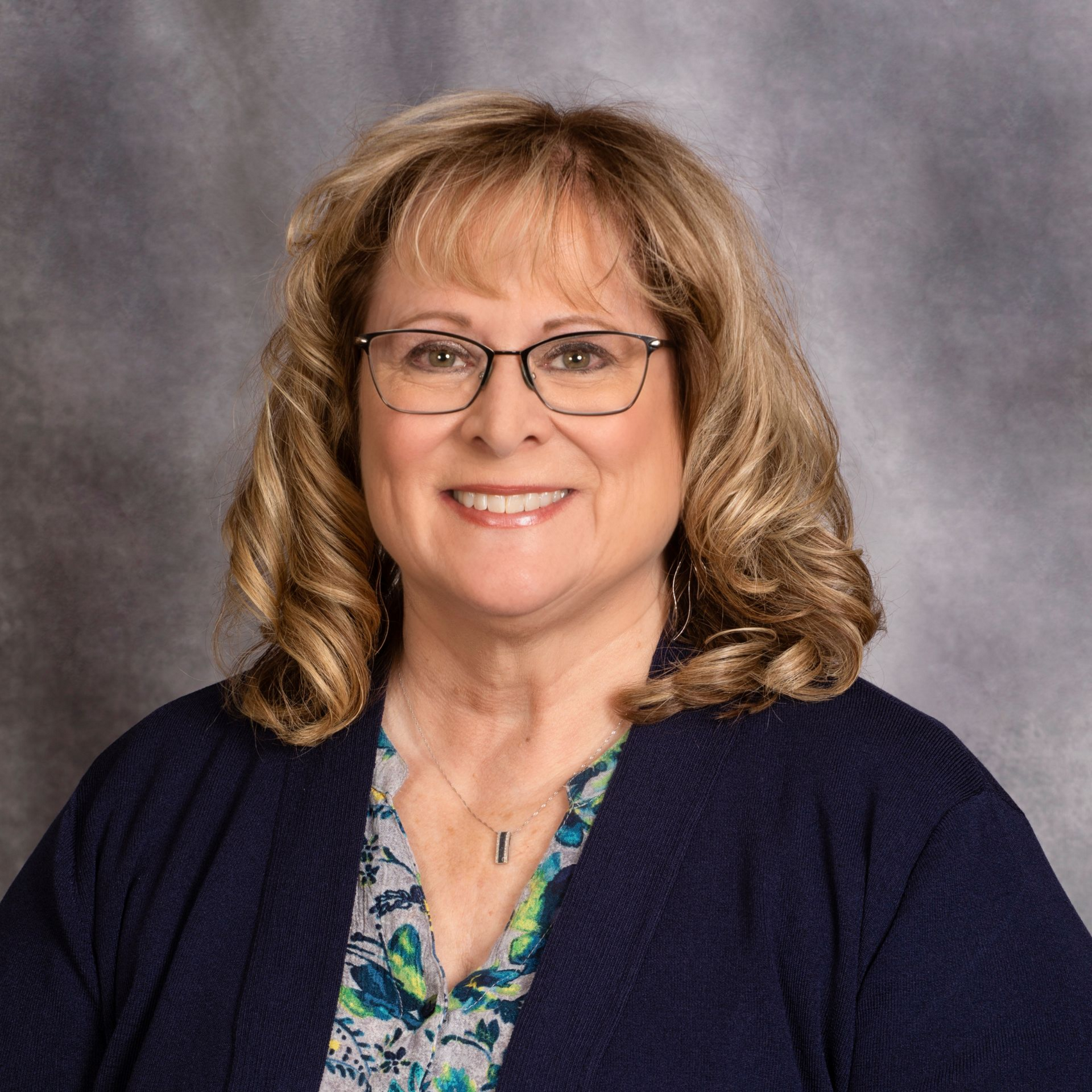 A man in a suit and tie smiles for the camera