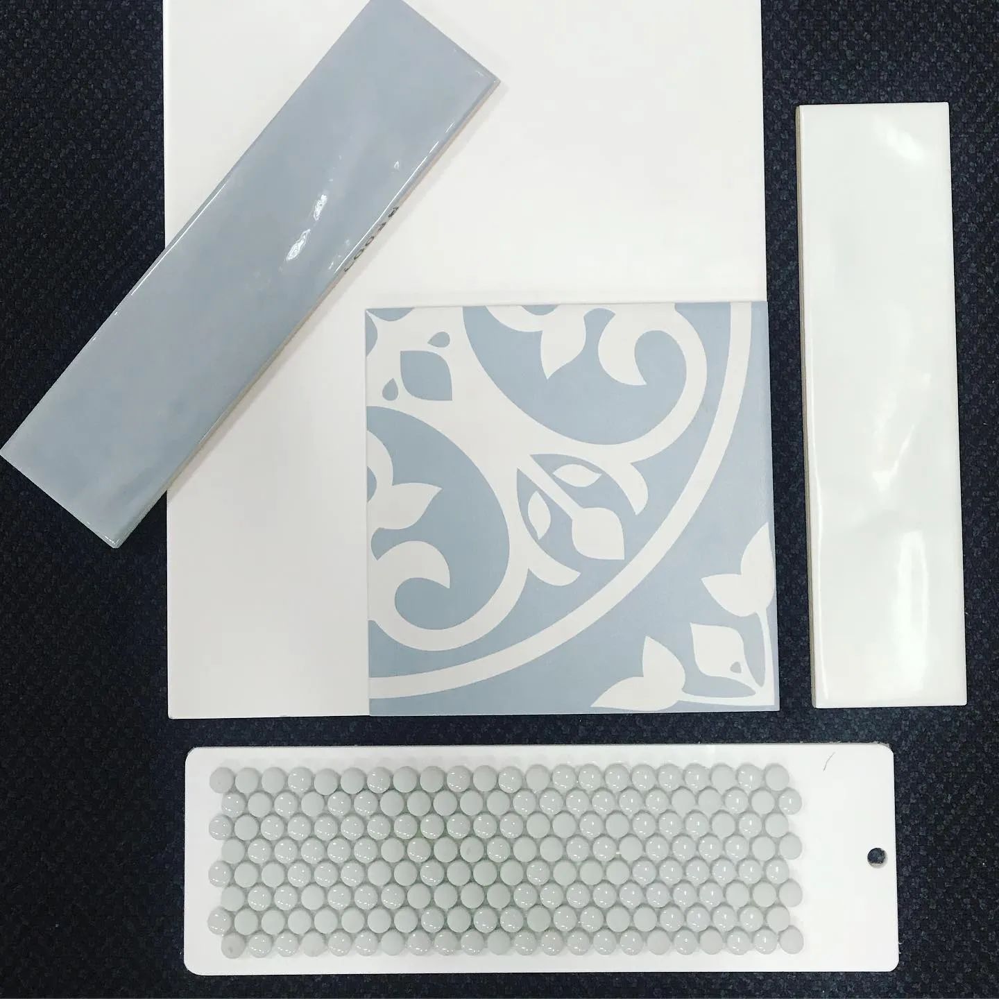 Tile Samples in Shades of White and Blue, Including a Decorative Patterned Tile and a Sheet of Small Mosaic Tiles — North Coast Tiles in Iluka, NSW